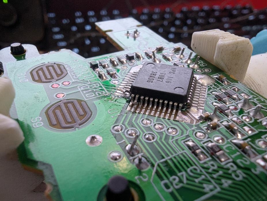 Main PCB with three pins on the IC lifted.