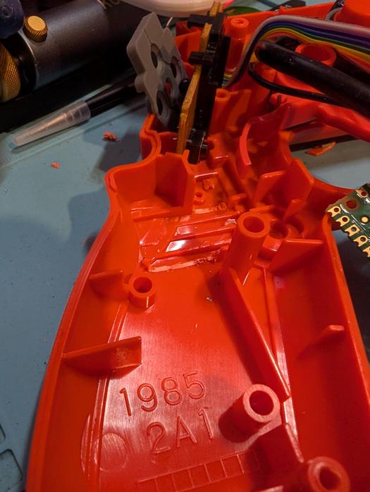 Closeup of handle, with two plastic tabs cut away.