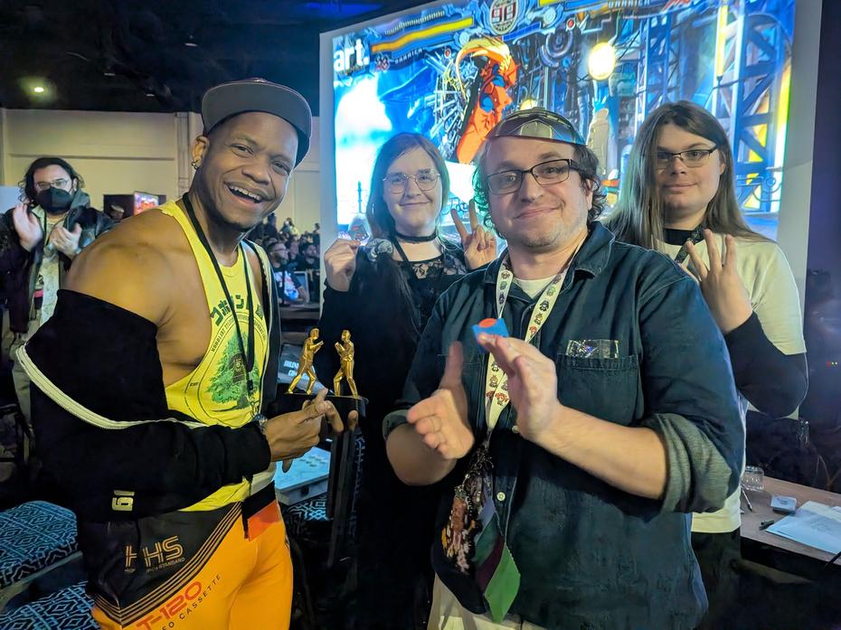 The top 4 players. First and second are in front, and third and fourth are behind. The grand champion holds the trophy I printed for this event.