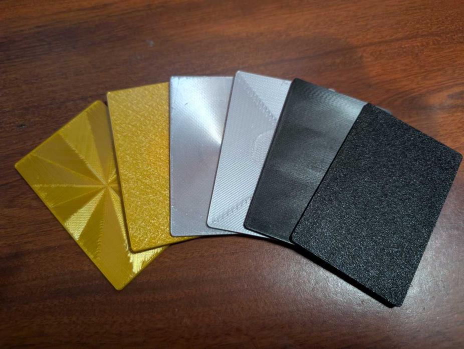Gold, silver, and black cards with an NFC token hidden inside.